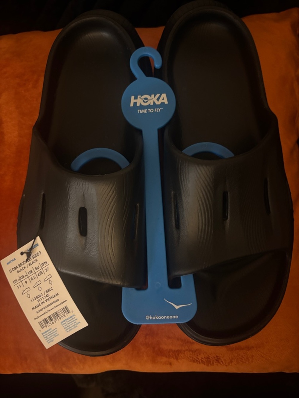 Hoka Black Slide Sandals with Blue Hanger